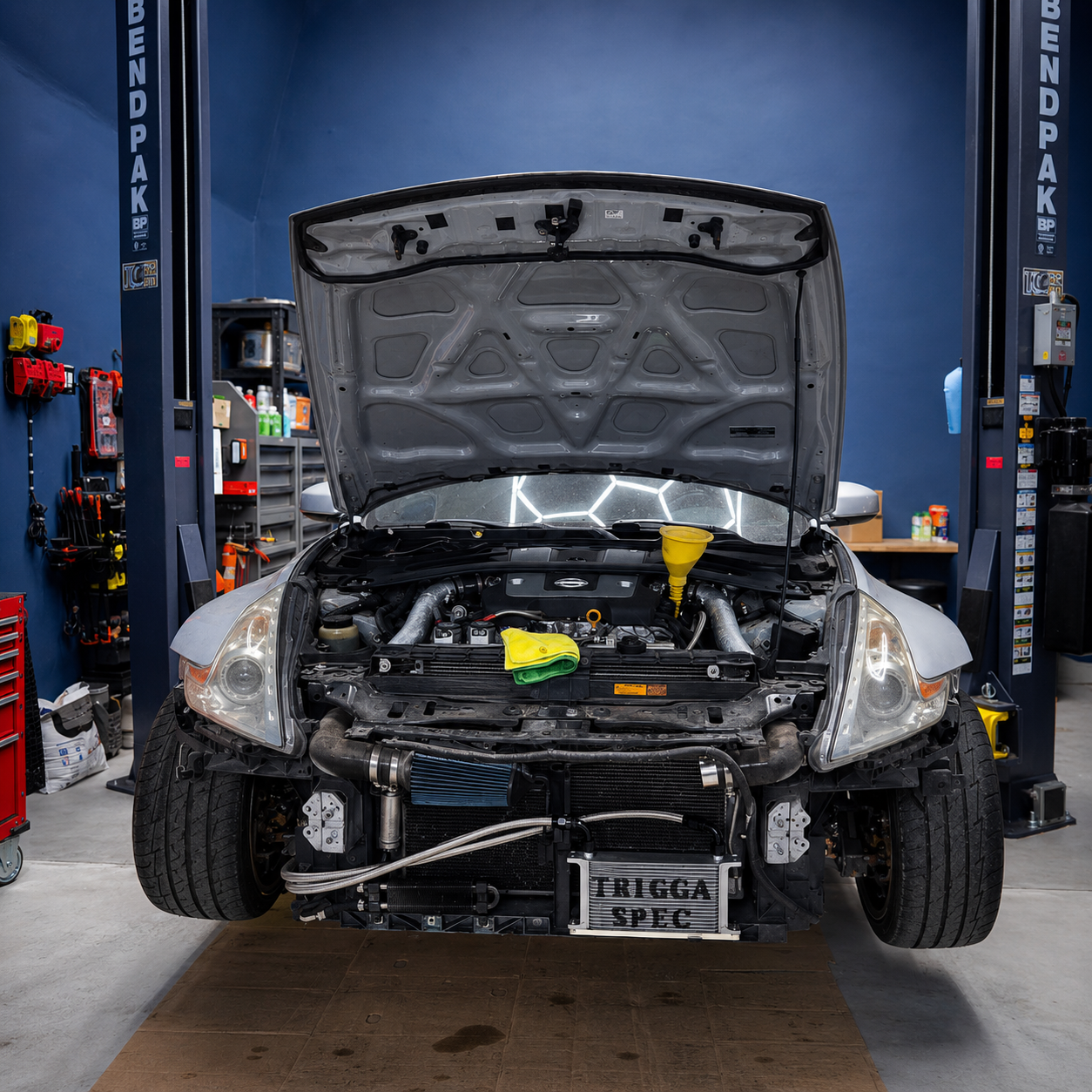 Car with open hood and Triggaspec oil cooler kit install
